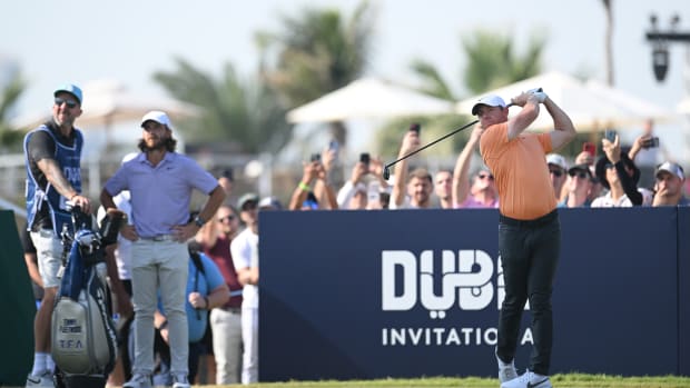 Rory McIlroy of Northern Ireland tees off on the 10th hole as Tommy Fleetwood of England looks on on Day Four of the Dubai Invitational at Dubai Creek Golf and Yacht Club on January 14, 2024 in Dubai, United Arab Emirates. 