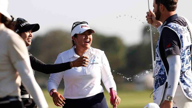 Patty Tavatanakit, left, celebrates with tournament winner Lilia Vu, center, and Vu's caddie, right, following the final round of the Annika on Sunday, Nov. 12, 2023, in Belleair, Fla.