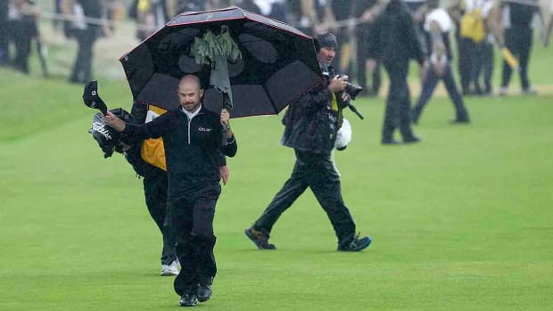 United States' Brian Harman walks up the 18th fairway and reacts to the crowd during the final day of the British Open Golf Championships at the Royal Liverpool Golf Club in Hoylake, England, Sunday, July 23, 2023.