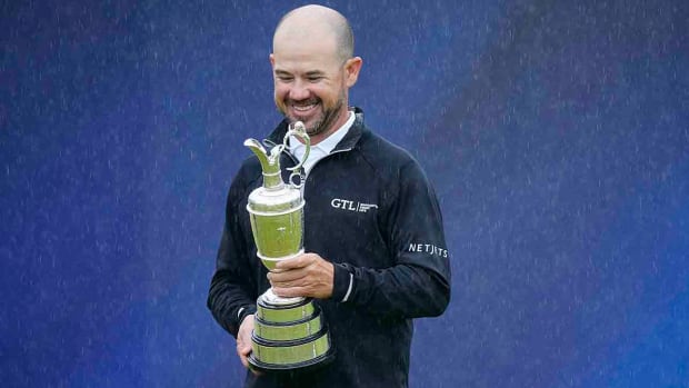 Brian Harman poses as he holds the Claret Jug trophy for winning the 2023 British Open at the Royal Liverpool Golf Club in Hoylake, England.