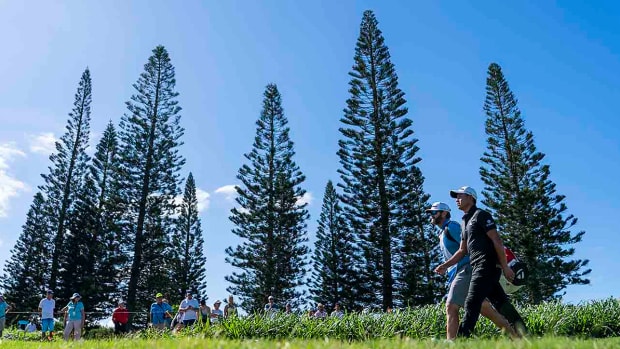 Collin Morikawa and his caddie walk on the third hole during the final round of the 2023 Sentry Tournament of Champions at Kapalua Resort in Hawai‘i.