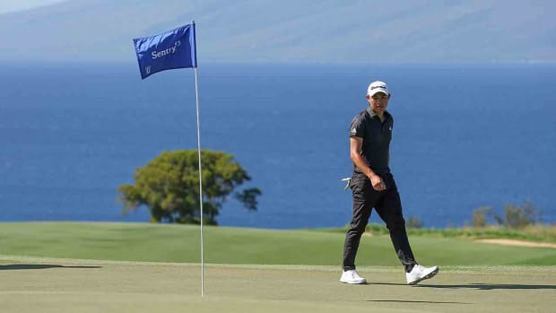 Collin Morikawa walks across the 13th green during the final round of the 2023 Sentry Tournament of Champions at Plantation Course at Kapalua Golf Club in Lahaina, Hawaii.