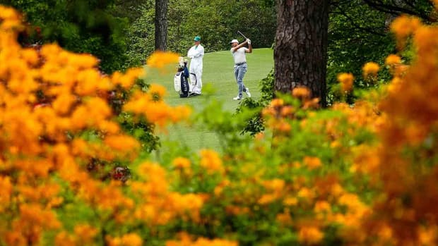 A player and caddie play Augusta National during a practice round for the 2023 Masters.