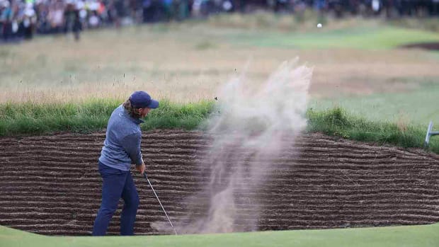 England's Tommy Fleetwood plays out of a bunker on the 16th hole during the second day of the 2023 British Open at Royal Liverpool Golf Club in Hoylake, England.