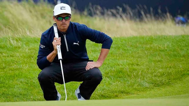 Rickie Fowler lines up his putt on the 18th green during the third round of the 2023 British Open in Hoylake, England.