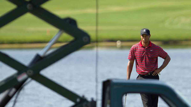Tiger Woods is framed by a TV truck at the 2011 Arnold Palmer Invitational.