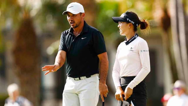 Jason Day of Australia and Lydia Ko of New Zealand talk on the second green during the final round of the Grant Thornton Invitational at Tiburon Golf Club on Dec. 10, 2023 in Naples, Fla.