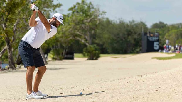 Dustin Johnson hits out of a bunker in the 2023 LIV Golf opener at Mayakoba.