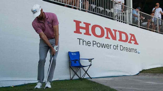 Chris Kirk chips near a grandstand at the 2023 Honda Classic.