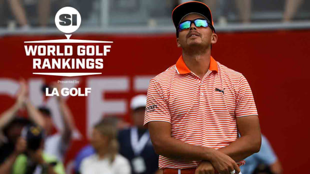 Rickie Fowler looks skyward after winning the 2023 Rocket Mortgage Classic, alongside the SI World Golf Rankings logo.