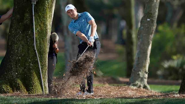 Jordan Spieth hits from the pine straw in the first round of the 2023 Players Championship.
