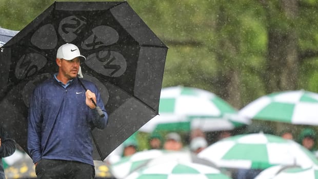 LIV golfer Brooks Koepka is in command of the Masters with a four-stroke lead in the third round after play was suspended because of inclement weather at Augusta National.