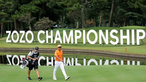 Rickie Fowler and his caddie walk on the 16th hole during the final round of the 2022 Zozo Championship at Accordia Golf Narashino Country Club in Japan.