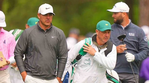 Brooks Koepka and his caddie Ricky Elliott are pictured during the 2023 Masters.