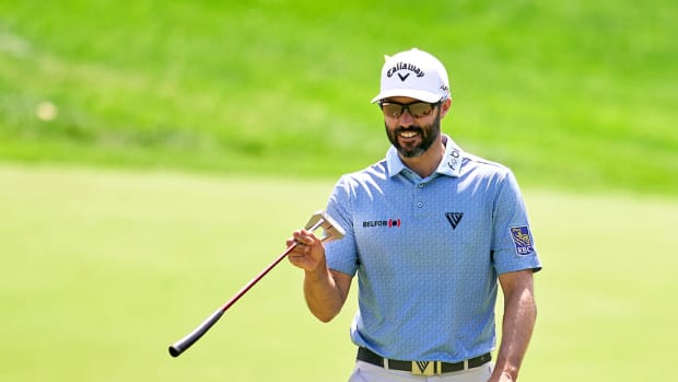 Canadian PGA Tour golfer Adam Hadwin points out a putting line.