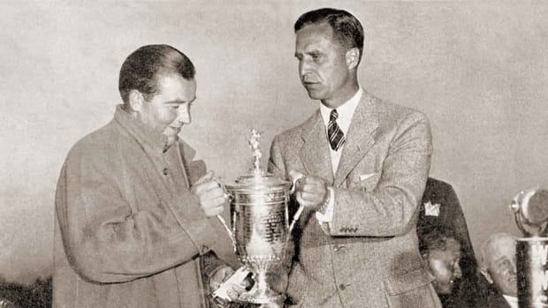 Sam Parks receives the U.S. Open trophy in 1935 from USGA President Prescott Bush.
