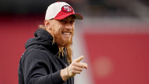 49ers tight end George Kittle points to fans before a game.