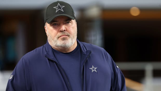 Cowboys coach Mike McCarthy stands on the sidelines during a playoff game against the Packers.