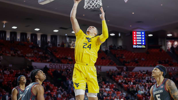 Jan 17, 2024; Norman, Oklahoma, USA; West Virginia Mountaineers forward Patrick Suemnick (24) shoots against the Oklahoma Sooners during the first half at Lloyd Noble Center.