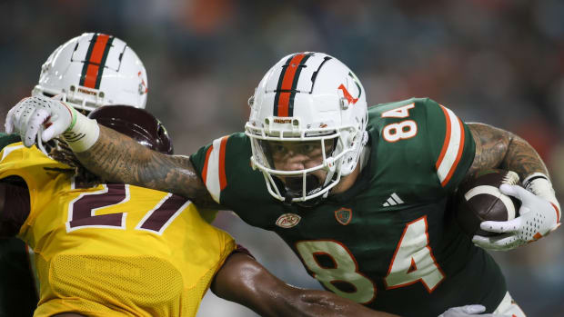 Sep 14, 2023; Miami Gardens, Florida, USA; Miami Hurricanes tight end Cam McCormick (84) runs with the football against Bethune Cookman Wildcats cornerback Stephen Sparrow (27) during the first quarter at Hard Rock Stadium. Mandatory Credit: Sam Navarro-USA TODAY Sports
