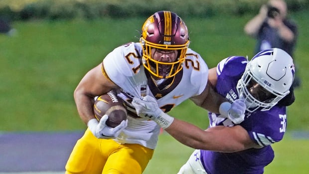 Sep 23, 2023; Evanston, Illinois, USA; Minnesota Golden Gophers running back Bryce Williams (21) tries to run past Northwestern Wildcats linebacker Bryce Gallagher (32) during the first quarter at Ryan Field.