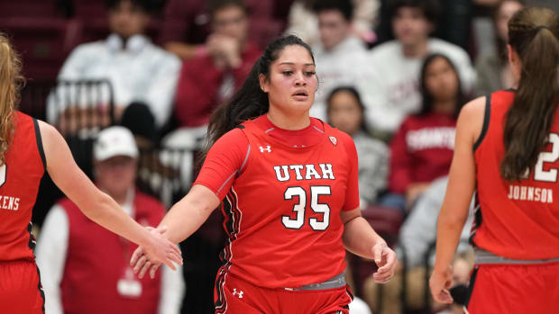 Jan 20, 2023; Stanford, California, USA; Utah Utes forward Alissa Pili (35) is congratulated by guard Gianna Kneepkens (left) and forward Jenna Johnson (right) during the third quarter against the Stanford Cardinal at Maples Pavilion. Mandatory Credit: Darren Yamashita-USA TODAY Sports
