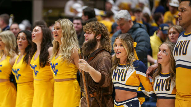 Jan 13, 2024; Morgantown, West Virginia, USA; The West Virginia Mountaineers mascot leads the fans in Country Roads after defeating the Texas Longhorns at WVU Coliseum. Mandatory Credit: Ben Queen-USA TODAY Sports  