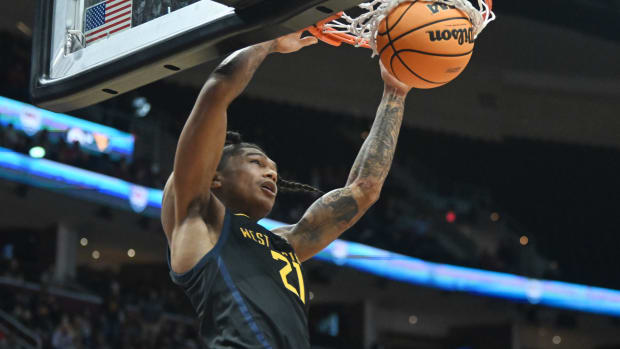 Dec 30, 2023; Cleveland, Ohio, USA; West Virginia Mountaineers guard RaeQuan Battle (21) dunks during the second half against the Ohio State Buckeyes at Rocket Mortgage FieldHouse. Mandatory Credit: Ken Blaze-USA TODAY Sports