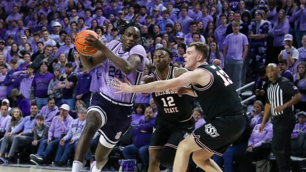 Jan 20, 2024; Manhattan, Kansas, USA; Kansas State Wildcats forward Arthur Maluma (24) drives to the basket against Oklahoma State Cowboys guard Javon Small (12) and guard Connor Dow (13) during the first half at Bramlage Coliseum. Mandatory Credit: Scott Sewell-USA TODAY Sports