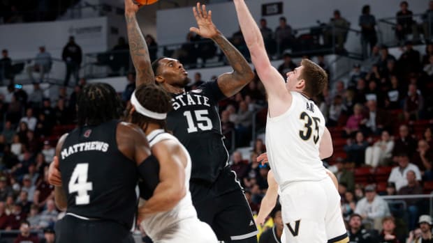 Jan 20, 2024; Starkville, Mississippi, USA; Mississippi State Bulldogs forward Jimmy Bell Jr. (15) shoots as Vanderbilt Commodores forward Carter Lang (35) defends during the first half at Humphrey Coliseum. Mandatory Credit: Petre Thomas-USA TODAY Sports
