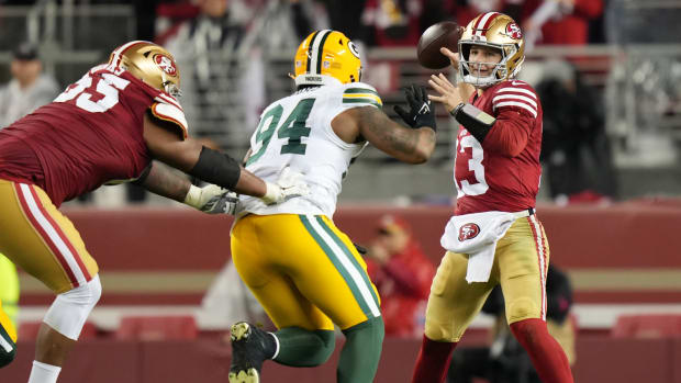 January 20, 2024; Santa Clara, CA, USA; San Francisco 49ers quarterback Brock Purdy (13) passes under pressure from Green Bay Packers defensive end Karl Brooks (94) during the third quarter in a 2024 NFC divisional round game at Levi's Stadium. Mandatory Credit: Kyle Terada-USA TODAY Sports  
