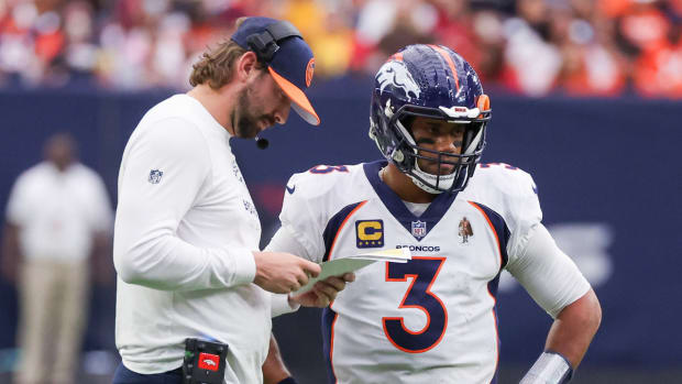Quarterback coach Davis Webb talks to Denver Broncos quarterback Russell Wilson (3) during a Houston Texans timeout in the second quarter at NRG Stadium.