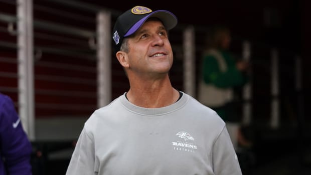 Ravens coach John Harbaugh smiles