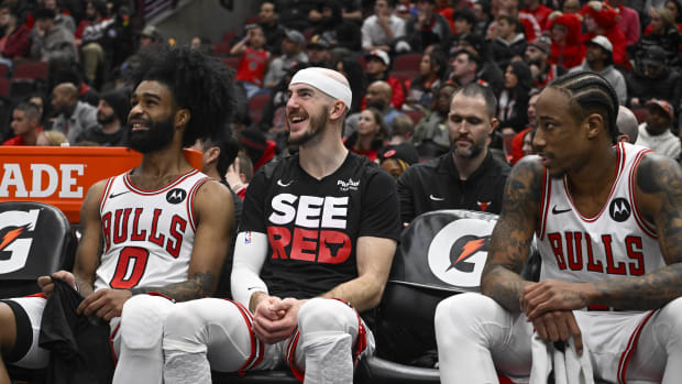 Chicago Bulls guard Coby White (0), guard Alex Caruso (6) and forward DeMar DeRozan (11) laugh on the bench a
