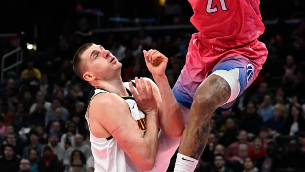 Mar 22, 2023; Washington, District of Columbia, USA; Denver Nuggets guard Collin Gillespie (21) dunks as Denver Nuggets center Nikola Jokic (15) looks on during the second half at Capital One Arena. Mandatory Credit: Brad Mills-USA TODAY Sports