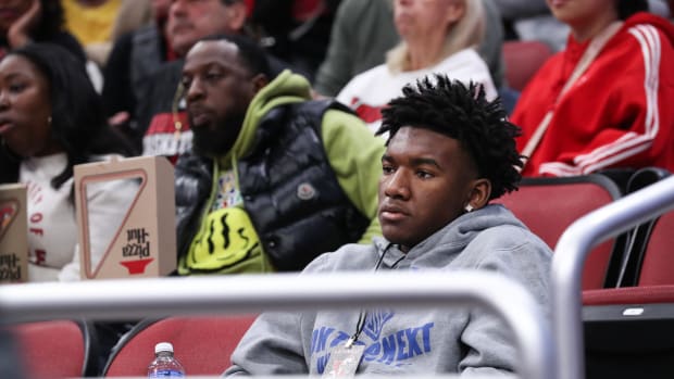 U of L recruit Karter Knox watches their game against Pepperdine at the Yum Center in Louisville, Ky. on Dec. 17, 2023.