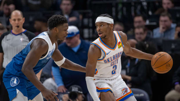 Jan 20, 2024; Minneapolis, Minnesota, USA; Oklahoma City Thunder guard Shai Gilgeous-Alexander (2) looks to pass the ball as Minnesota Timberwolves guard Anthony Edwards (5) plays defense in the second half at Target Center.