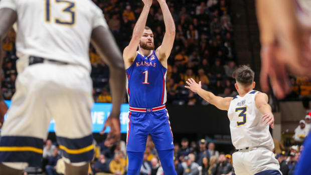 Jan 20, 2024; Morgantown, West Virginia, USA; Kansas Jayhawks center Hunter Dickinson (1) shoots a three-point shot during the first half against the West Virginia Mountaineers at WVU Coliseum. Mandatory Credit: Ben Queen-USA TODAY Sports