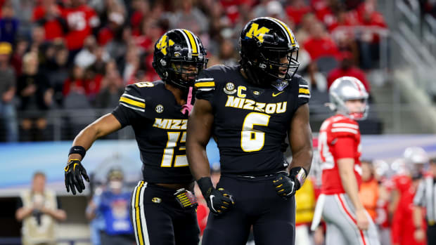 Missouri Tigers defensive lineman Darius Robinson (6) and Missouri Tigers defensive back Daylan Carnell (13) celebrate during the first quarter against the Ohio State Buckeyes at AT&T Stadium.