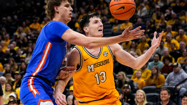 Missouri Tigers forward Jesus Carralero Martin (13) loses control of the ball as he drives against Florida Gators center Micah Handlogten (3) during the first half at Mizzou Arena.