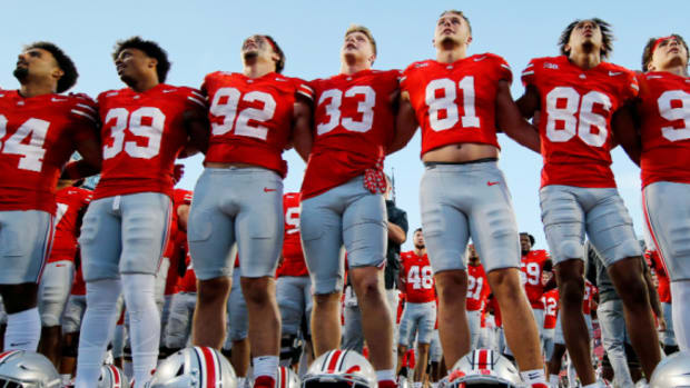 Ohio State Buckeyes players celebrate after a college football game in the Big Ten.