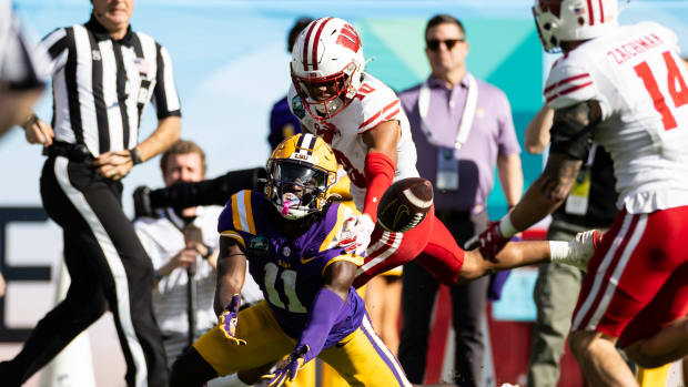 Jan 1, 2024; Tampa, FL, USA; Wisconsin Badgers cornerback Nyzier Fourqurean (10) breaks up a pass to LSU Tigers wide receiver Brian Thomas Jr. (11) during the second half at the Reliaquest Bowl at Raymond James Stadium. Mandatory Credit: Matt Pendleton-USA TODAY Sports