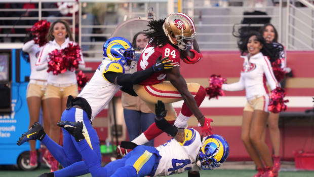 Jan 7, 2024; Santa Clara, California, USA; San Francisco 49ers wide receiver Chris Conley (84) is tackled by Los Angeles Rams cornerback Derion Kendrick (left) and safety John Johnson III (bottom) during the second quarter at Levi's Stadium. (Darren Yamashita / USA TODAY Sports).
