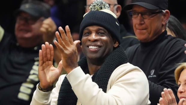 Jan 13, 2024; Boulder, Colorado, USA; Colorado Buffaloes football head coach Deion Sanders cheers in the second half of the game against the USC Trojans at the CU Events Center