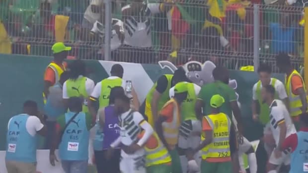 Cameroon players and fans pictured celebrating a late goal during a 3-2 win over Gambia at the Africa Cup of Nations in January 2024