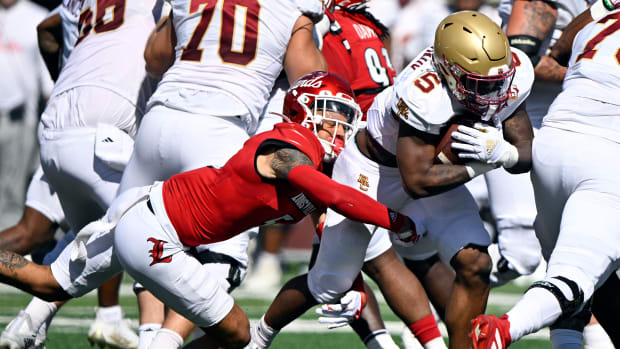 Sep 23, 2023; Louisville, Kentucky, USA; Boston College Eagles running back Kye Robichaux (5) runs the ball against Louisville Cardinals defensive back Josh Minkins (5) during the first quarter at L&N Federal Credit Union Stadium. Mandatory Credit: Jamie Rhodes-USA TODAY Sports