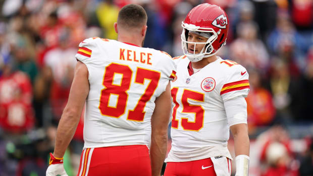 Kansas City Chiefs quarterback Patrick Mahomes (15) and tight end Travis Kelce (87) warm up before a game.