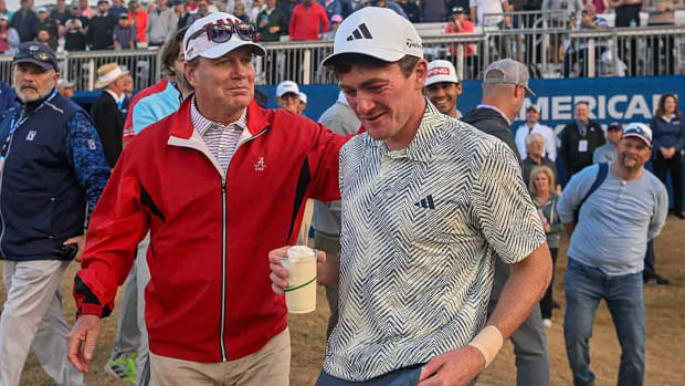 Alabama head golf coach Jay Seawell congratulates Nick Dunlapafter winning the American Express at PGA West, Dye Stadium Course on Jan. 21, 2024 in La Quinta, Calif.
