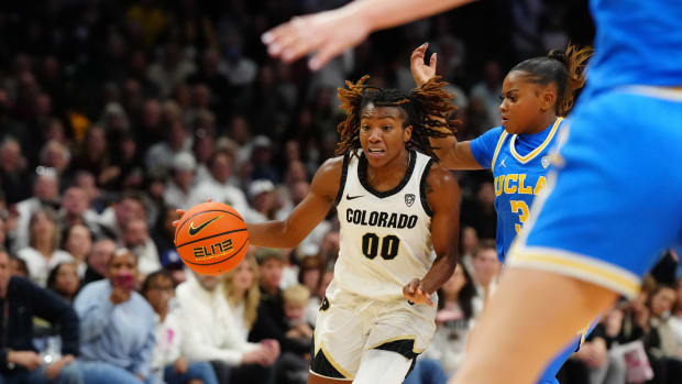 Jan 19, 2024; Boulder, Colorado, USA; Colorado Buffaloes guard Jaylyn Sherrod (00 controls the ball past UCLA Bruins guard Londynn Jones (3) in the second half at the CU Events Center