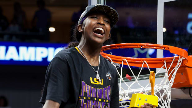 Apr 2, 2023; Dallas, TX, USA; LSU Lady Tigers guard Flau'jae Johnson (4) reacts while cutting down a piece of the net after defeating the Iowa Hawkeyes during the final round of the Women's Final Four NCAA tournament at the American Airlines Center.